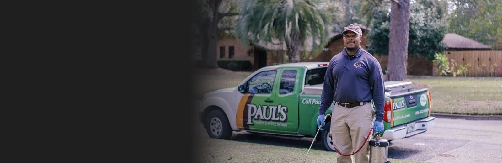 Paul's Pest employee standing in front of truck