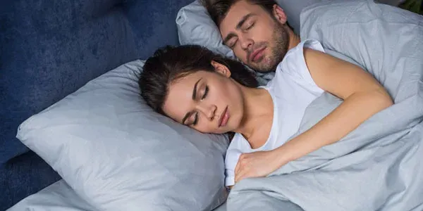 Couple sleeping peacefully in bed bug free bed